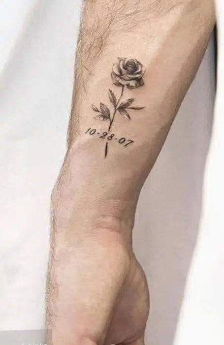 Tiny pink rose tattoo on the wrist